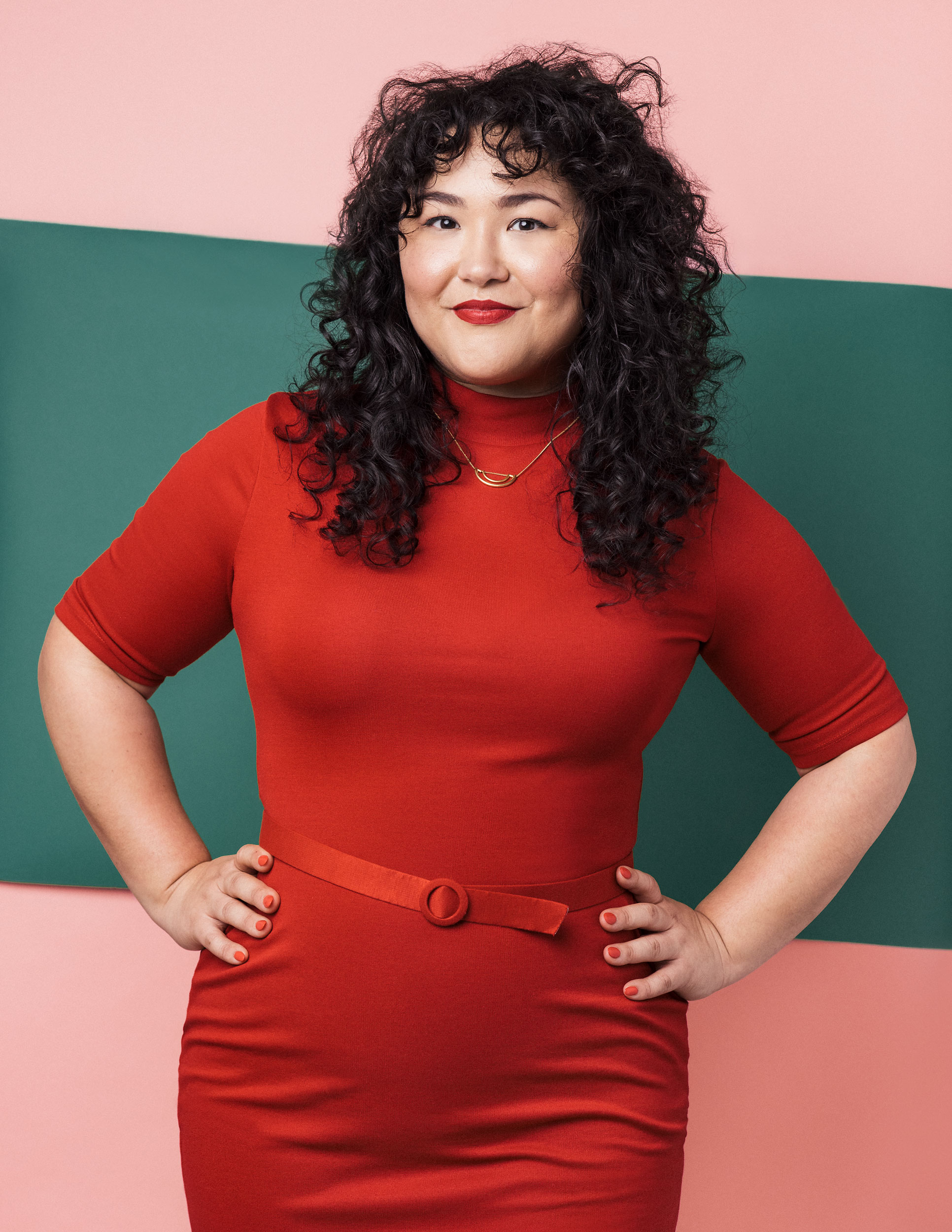 Hily Trowbridge in a vintage red dress against a green and pink backdrop that's bold and fun